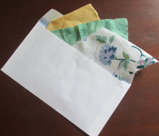 Fabric samples sticking out of an unsealed envelope